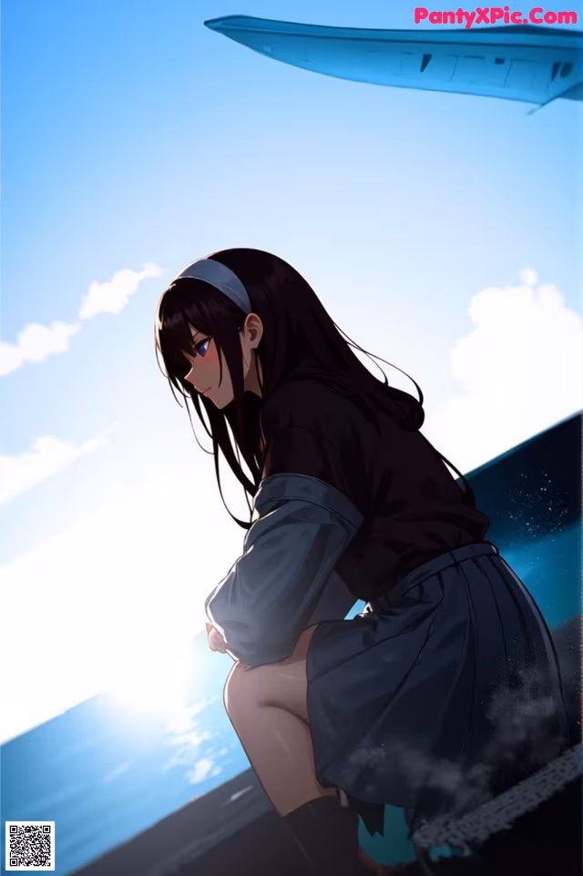 A woman sitting on top of a beach next to the ocean.