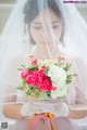 a bride holding a bouquet of flowers in her hands